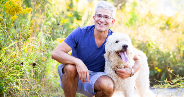 older man with dog