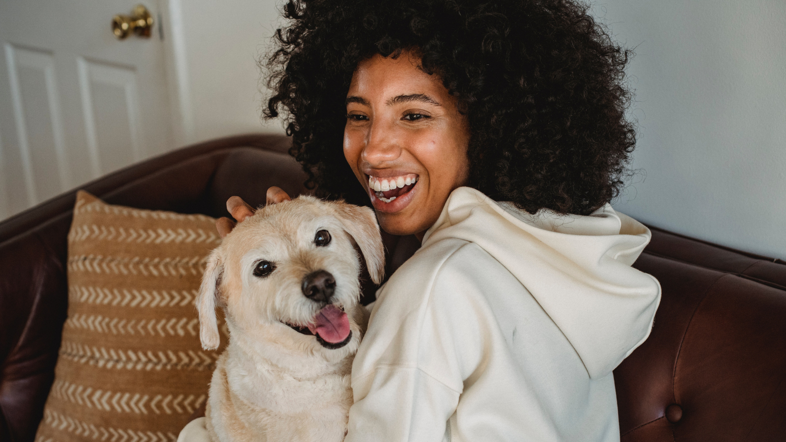 Celebrating Black History Month. A female smiling with her dog.